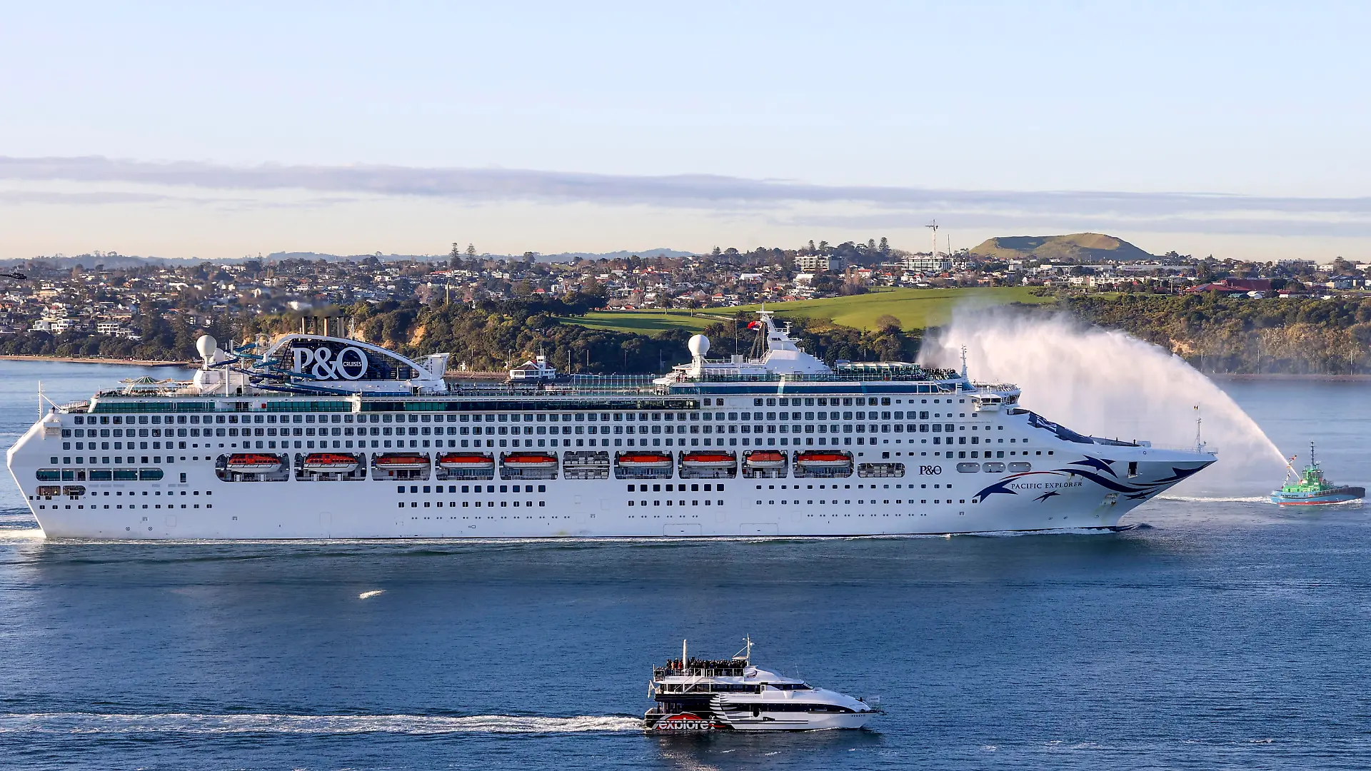 The Pacific Explorer sails into the Waitemata Harbour, in Auckland, New Zealand, Friday, Aug. 12, 2022. New Zealand has welcomed the first cruise ship to return since the coronavirus pandemic began, signaling a long-sought return to normalcy for the nation's tourism industry. (Brett Phibbs/New Zealand Herald)
