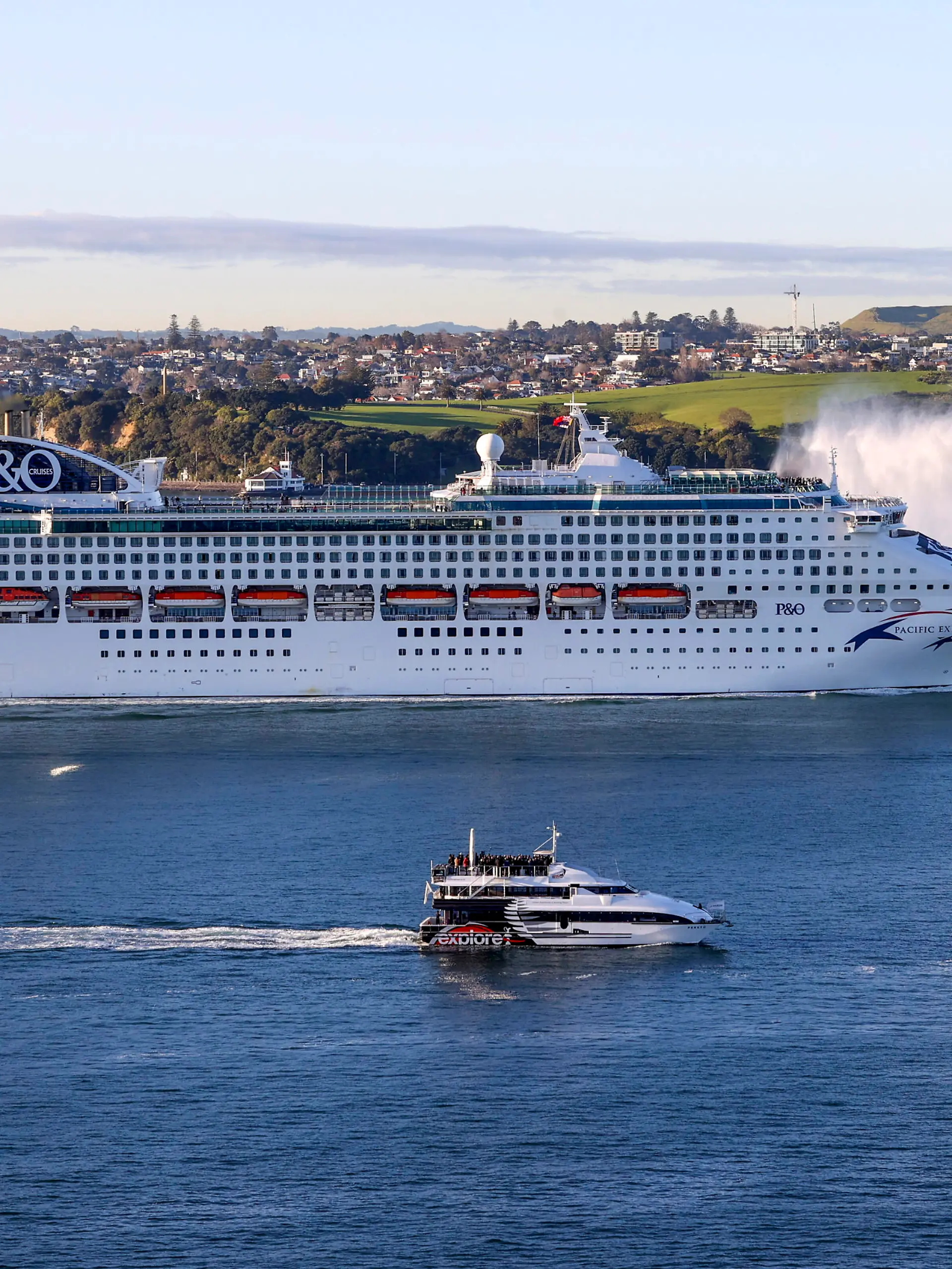 The Pacific Explorer sails into the Waitemata Harbour, in Auckland, New Zealand, Friday, Aug. 12, 2022. New Zealand has welcomed the first cruise ship to return since the coronavirus pandemic began, signaling a long-sought return to normalcy for the nation's tourism industry. (Brett Phibbs/New Zealand Herald)