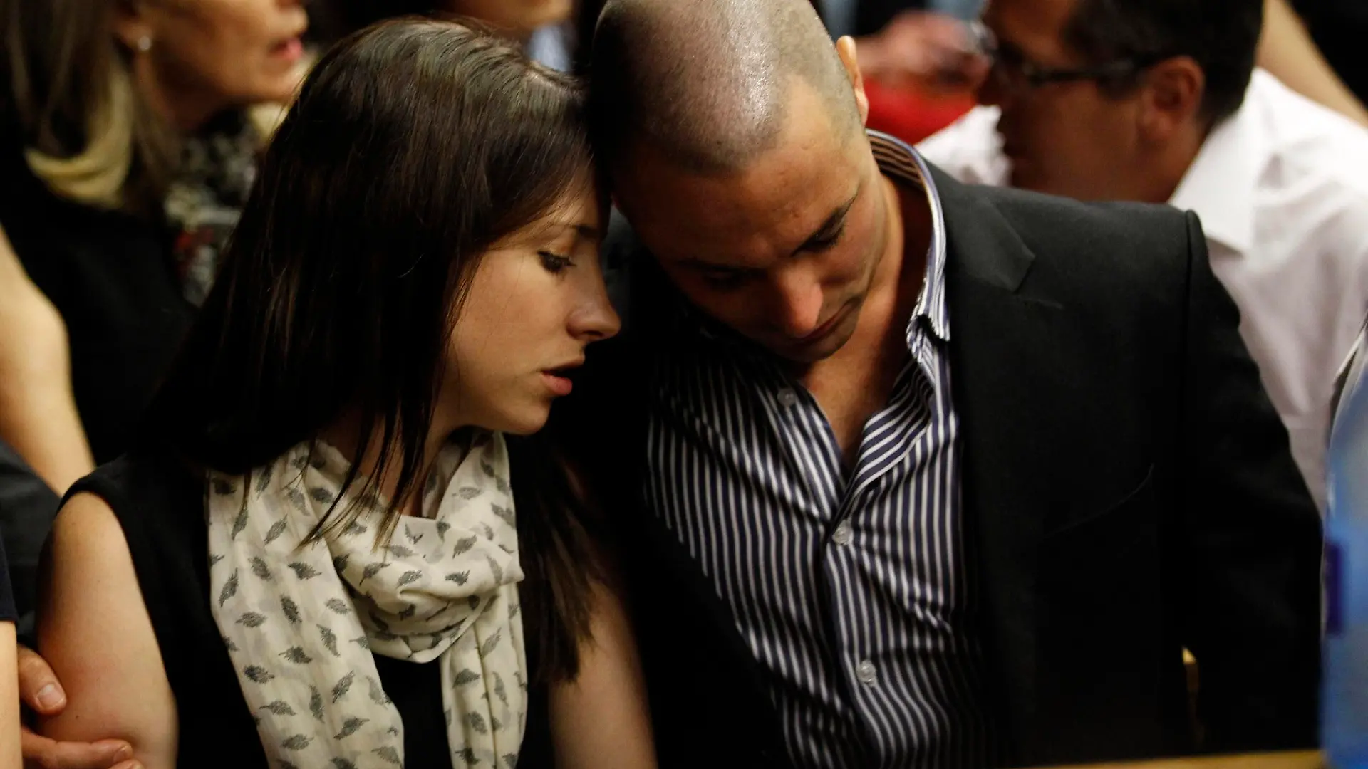 Oscar Pistorius's sister Aimee and brother Carl await the start of court proceedings in the Pretoria Magistrates court, February 19, 2013. Pistorius, a double amputee who became one of the biggest names in world athletics, was applying for bail aftr being charged in court with shooting dead his girlfriend, 30-year-old model Reeva Steenkamp, in his Pretoria house. REUTERS/Siphiwe Sibeko (SOUTH AFRICA - Tags: CRIME LAW SPORT ATHLETICS TPX IMAGES OF THE DAY)