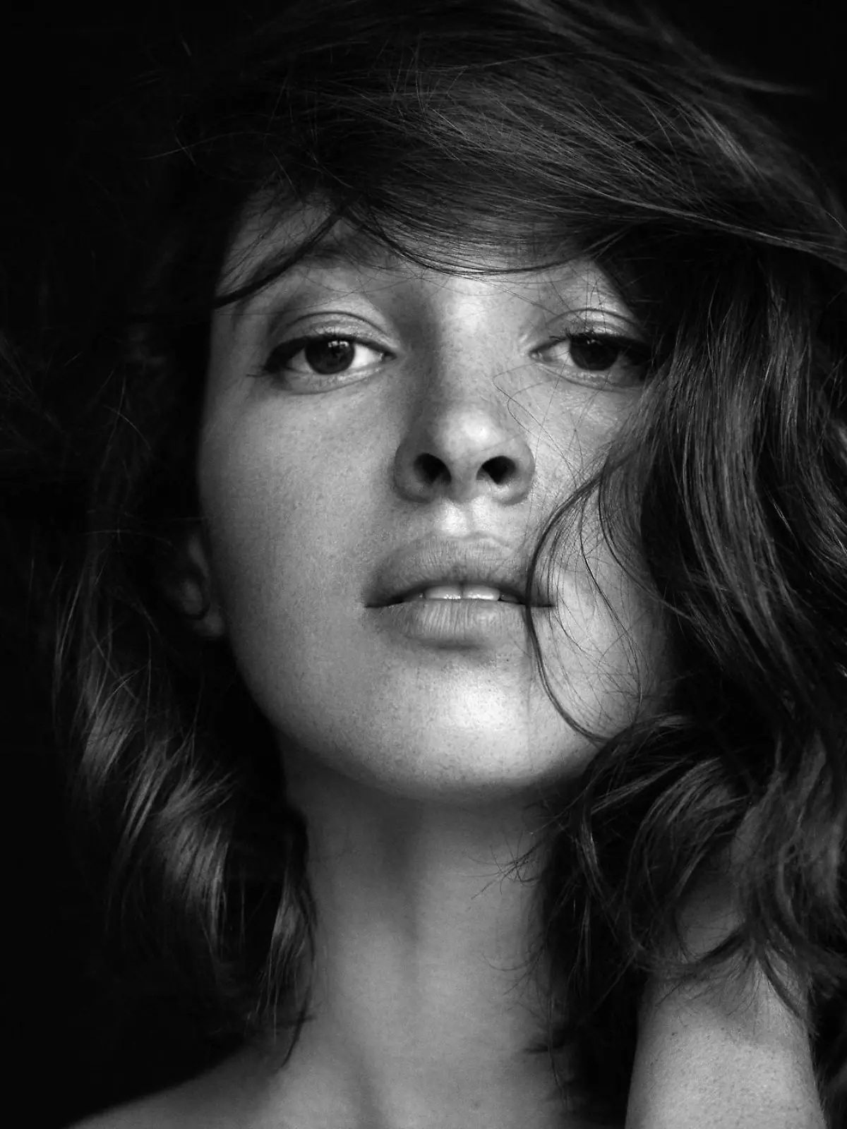 Studio shot of young beautiful woman. Professional make-up and hairstyle.