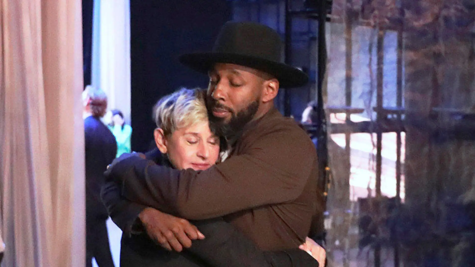 FILE - In this photo released by Warner Bros., talk show host Ellen DeGeneres embraces Stephen "tWitch" Boss during a taping of "The Ellen DeGeneres Show" at the Warner Bros. lot in Burbank, Calif. Boss, a longtime DJ and co-executive producer on the talk show “The Ellen DeGeneres Show” and former contestant on the dance competition show, “So You Can Think You Can Dance” has died at the age of 40. (Photo by Michael Rozman/Warner Bros., File)