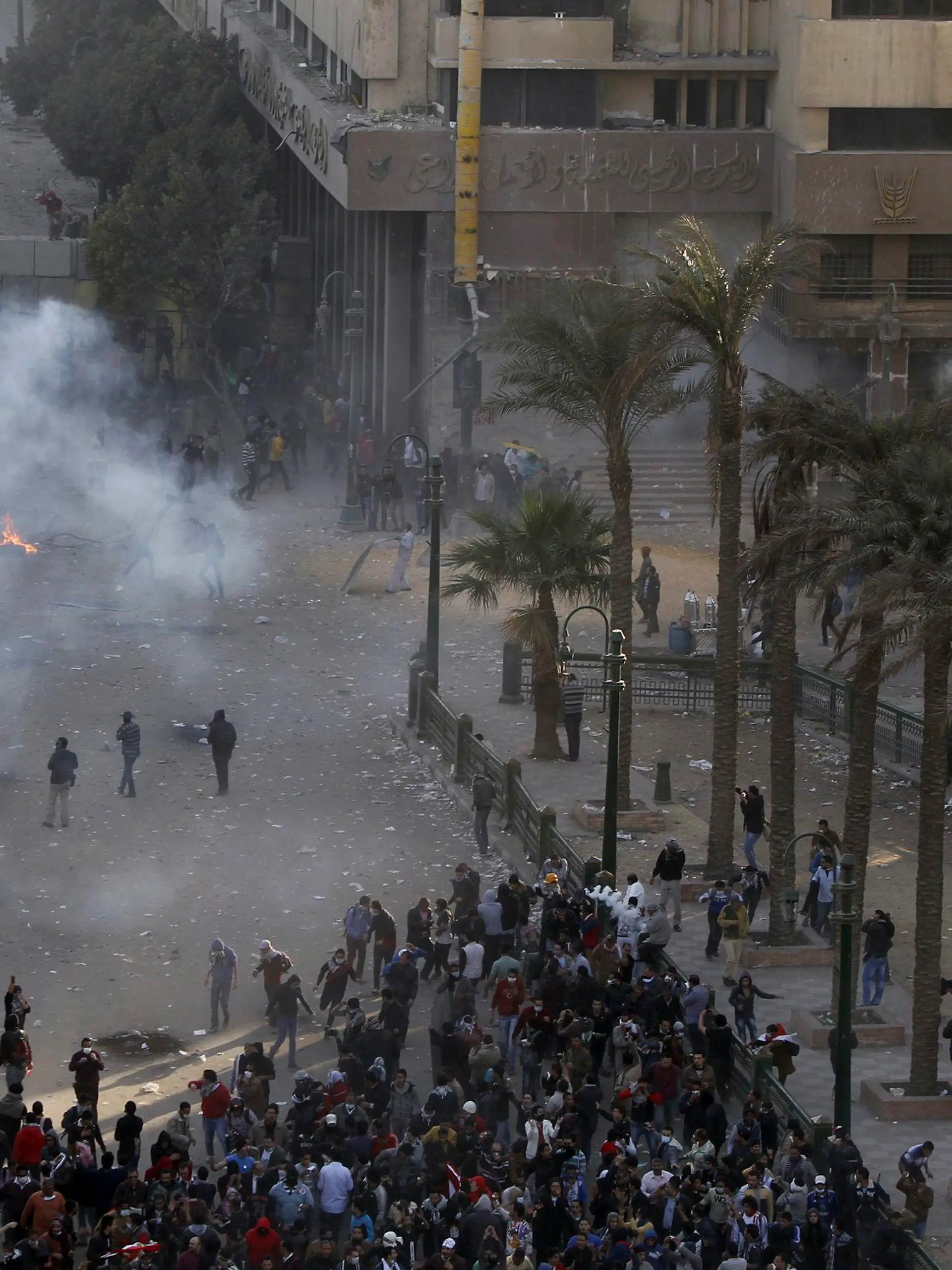 Protesters opposing Egyptian President Mohamed Mursi flee from tear gas fired by riot police during clashes along Sheikh Rihan street near Tahrir Square in Cairo January 25, 2013. Hundreds of youths fought Egyptian police in Cairo on Friday on the second anniversary of the revolt that toppled Hosni Mubarak and brought the election of an Islamist president who protesters accuse of riding roughshod over the new democracy. Opponents of Mursi and his Muslim Brotherhood allies began massing in Cairo's Tahrir Square to revive the demands of a revolution they say has been betrayed by Islamists. REUTERS/Amr Abdallah Dalsh (EGYPT - Tags: POLITICS CIVIL UNREST ANNIVERSARY)