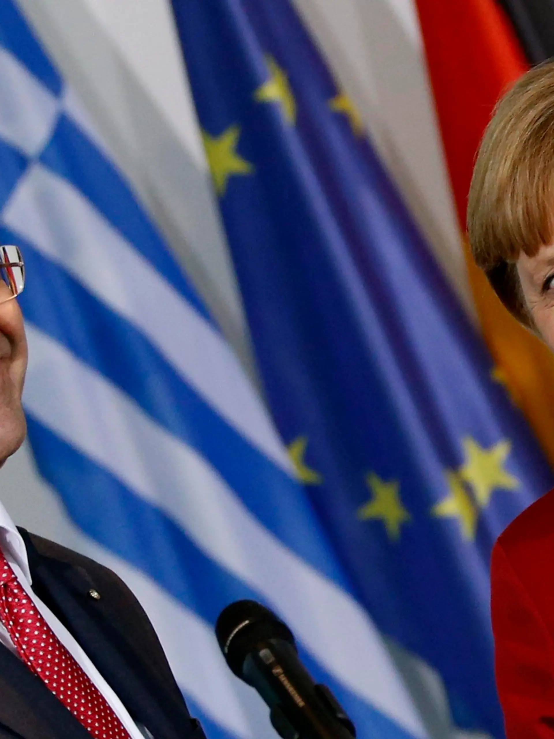 Greek Prime Minister Antonis Samaras (L) and German Chancellor Angela Merkel smile as they address the media at the Chancellery in Berlin January 8, 2013.  Greece is delivering on tough economic reforms and its European partners are providing support, Prime Minister Antonis Samaras said on Tuesday during a visit to Germany.         REUTERS/Fabrizio Bensch (GERMANY - Tags: POLITICS)