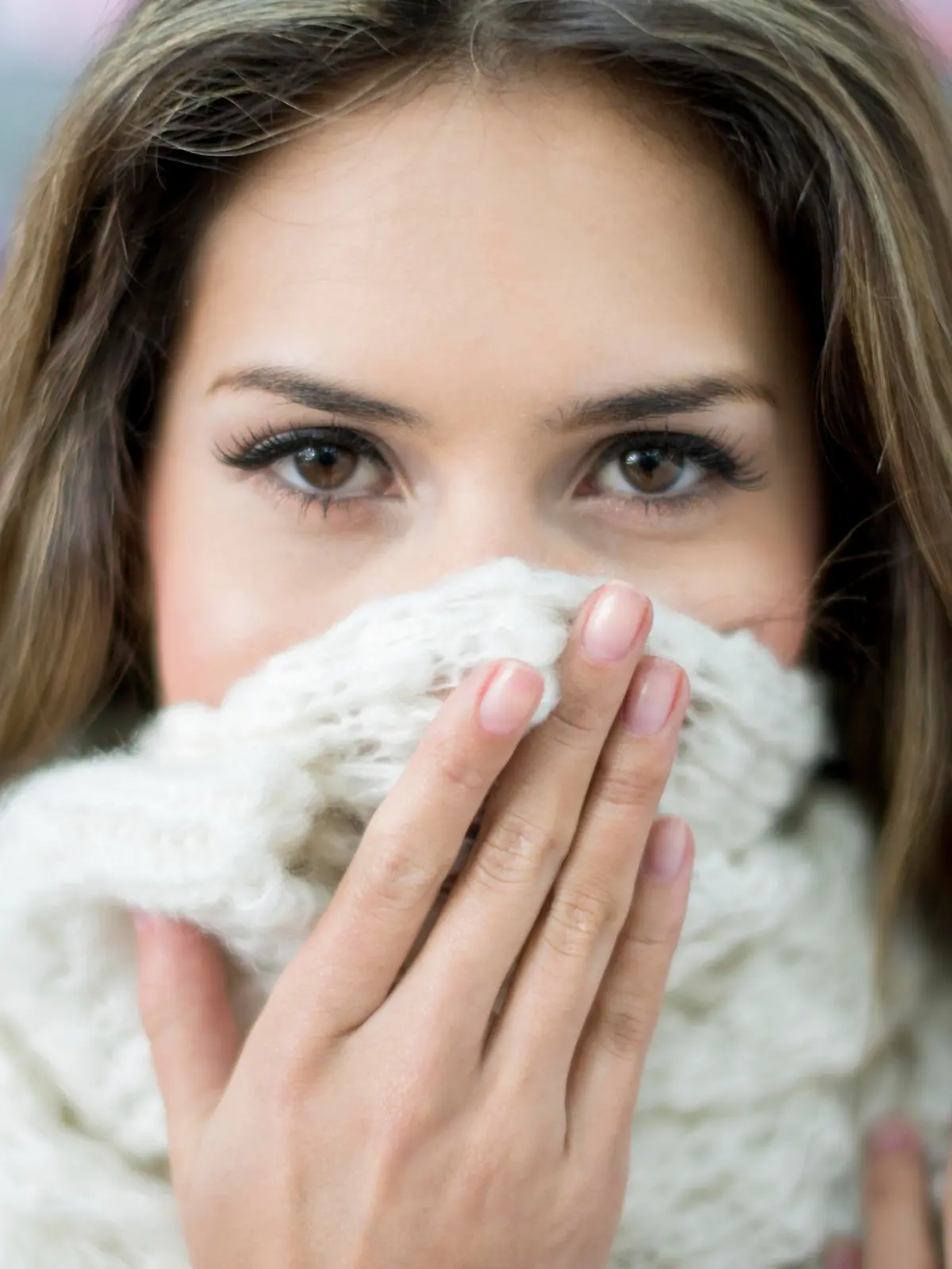 Sick woman at the pharmacy covering her face with a scarf 