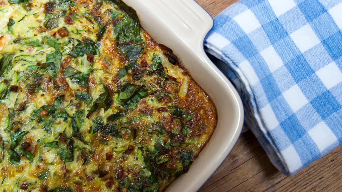 Just-baked egg casserole with zucchini and spinach.