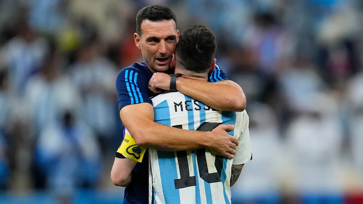 Argentina's head coach Lionel Scaloni embraces Argentina's Lionel Messi at the end of the World Cup quarterfinal soccer match between the Netherlands and Argentina, at the Lusail Stadium in Lusail, Qatar, Saturday, Dec. 10, 2022. (AP Photo/Natacha Pisarenko)