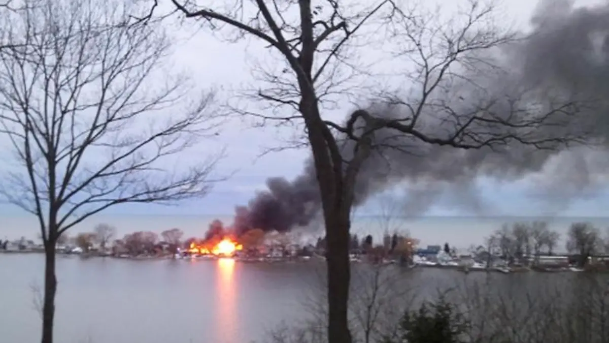 A fire burns on Lake Road after a suspect shot four firefighters responding to the blaze in Webster, New York, December 24, 2012. At least two upstate New York firefighters were shot and killed and two wounded on Monday at the scene of an early morning house fire in a suburb of Rochester, according to local news reports. REUTERS/WHEC/Christine VanTimmeren/Handout (UNITED STATES - Tags: CRIME LAW) NO SALES. NO ARCHIVES. FOR EDITORIAL USE ONLY. NOT FOR SALE FOR MARKETING OR ADVERTISING CAMPAIGNS