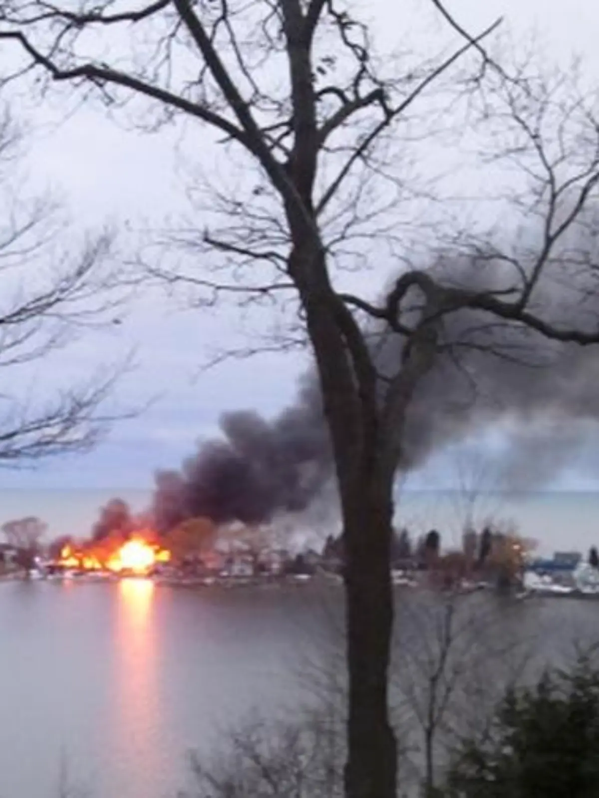 A fire burns on Lake Road after a suspect shot four firefighters responding to the blaze in Webster, New York, December 24, 2012. At least two upstate New York firefighters were shot and killed and two wounded on Monday at the scene of an early morning house fire in a suburb of Rochester, according to local news reports. REUTERS/WHEC/Christine VanTimmeren/Handout (UNITED STATES - Tags: CRIME LAW) NO SALES. NO ARCHIVES. FOR EDITORIAL USE ONLY. NOT FOR SALE FOR MARKETING OR ADVERTISING CAMPAIGNS