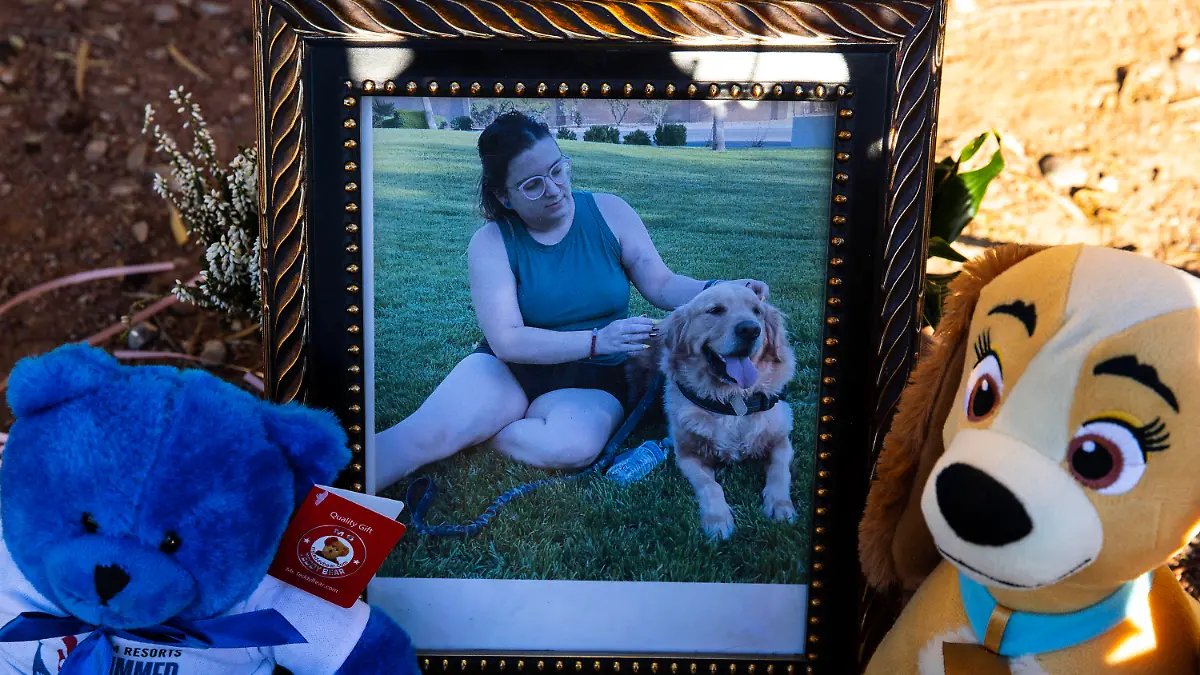 FILE - A portrait of Tina Tintor, 23, and her dog is displayed at a makeshift memorial site to honor them at South Rainbow Boulevard and Spring Valley Parkway, on Thursday, Nov. 4, 2021, in Las Vegas. Former Las Vegas Raiders player Henry Ruggs was sentenced Wednesday, Aug. 9, 2023, in Las Vegas, to at least three years in a Nevada prison for killing a TIntor and her dog in a fiery crash while driving his sports car drunk at speeds up to 156 mph on a city street nearly two years ago.  (Bizuayehu Tesfaye/Las Vegas Review-Journal via AP)