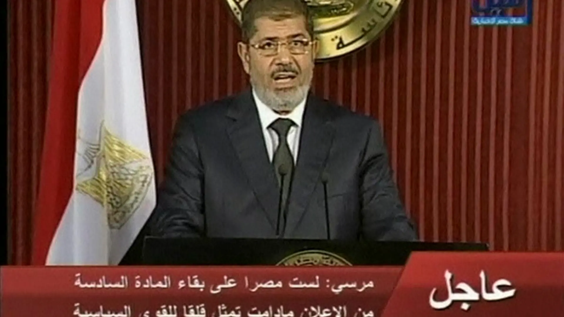 Egyptian President Mohamed Mursi speaks during a televised address in Cairo, in this still image taken from video made available to Reuters on December 6, 2012. Mursi invited political groups, judges and others to meet on Saturday for a national dialogue on a political road map after a referendum on a new constitution, which he signalled would go ahead as scheduled on Dec. 15. REUTERS/Nile TV via Reuters TV (EGYPT - Tags: POLITICS TPX IMAGES OF THE DAY) NO SALES. NO ARCHIVES. FOR EDITORIAL USE ONLY. NOT FOR SALE FOR MARKETING OR ADVERTISING CAMPAIGNS. THIS IMAGE HAS BEEN SUPPLIED BY A THIRD PARTY. IT IS DISTRIBUTED, EXACTLY AS RECEIVED BY REUTERS, AS A SERVICE TO CLIENTS. EGYPT OUT. NO COMMERCIAL OR EDITORIAL SALES IN EGYPT