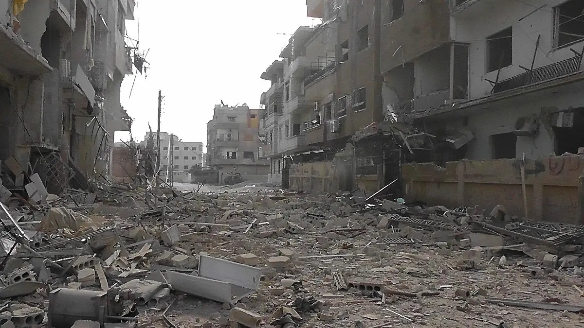 A view of buildings damaged by what activists said were missiles fired by a Syrian Air Force fighter jet loyal to Syria's President Bashar al-Assad in Daria, near Damascus, November 30, 2012. REUTERS/Kenan Al-Derani/Shaam News Network/Handout (SYRIA - Tags: CIVIL UNREST MILITARY POLITICS CONFLICT) FOR EDITORIAL USE ONLY. NOT FOR SALE FOR MARKETING OR ADVERTISING CAMPAIGNS. THIS IMAGE HAS BEEN SUPPLIED BY A THIRD PARTY. IT IS DISTRIBUTED, EXACTLY AS RECEIVED BY REUTERS, AS A SERVICE TO CLIENTS