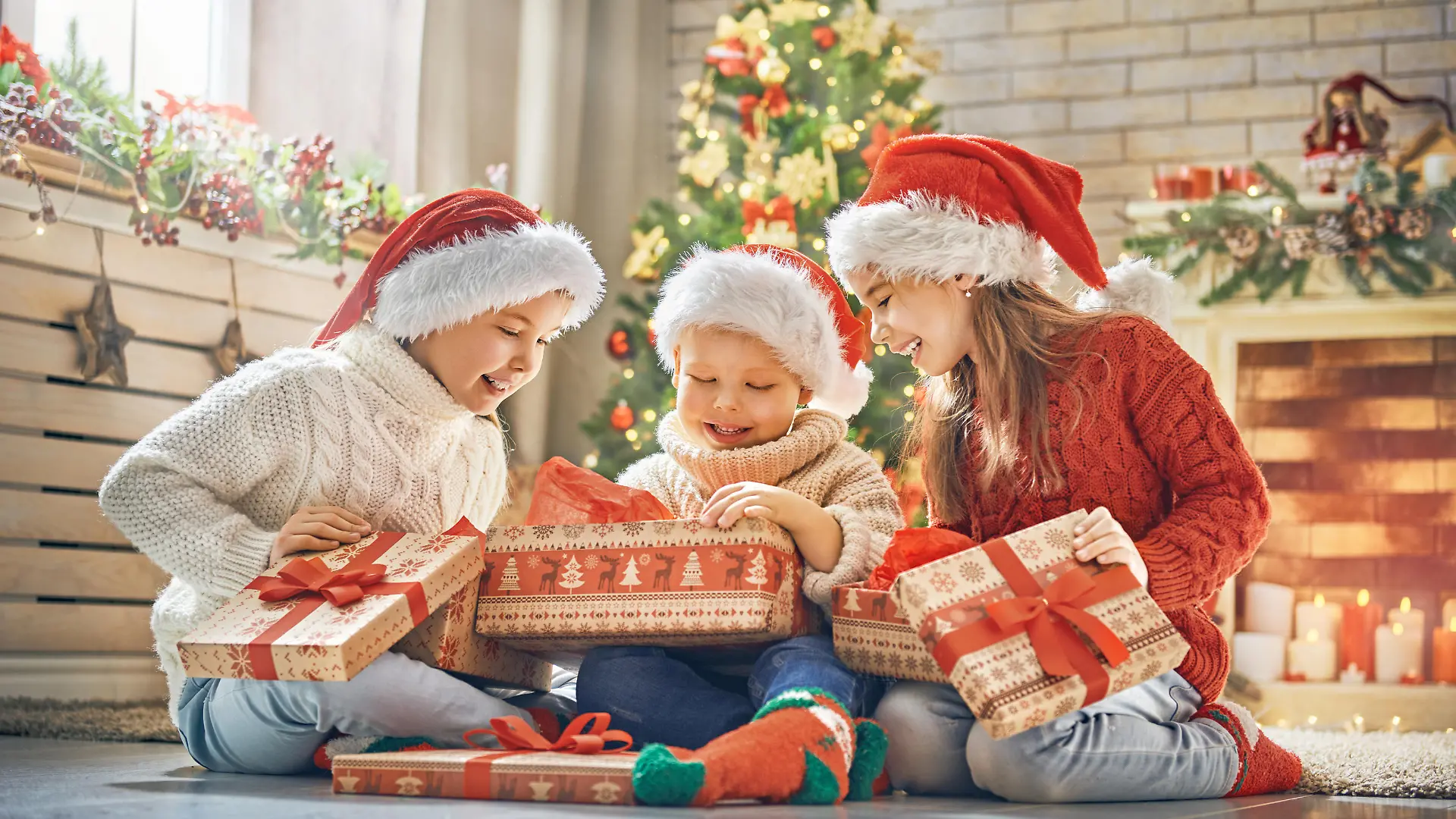 Merry Christmas and Happy Holidays! Cheerful cute children opening gifts. Kids having fun near tree in the morning. Loving family with presents in room.