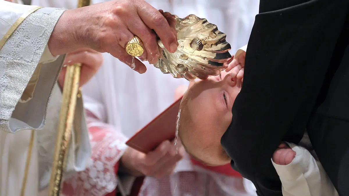 Pope Benedict XVI baptising a baby during the Baptism of the Lord mass at the Sistine Chapel at The Vatican. The Pontiff baptised 21 newborn babies in the Vatican's Sistine Chapel in a ceremony in which he condemned threats against the traditional family caused by societal change.SPAZIANI PHOTO/ OSSERVATORE ROMANO/HO January 9, 2011