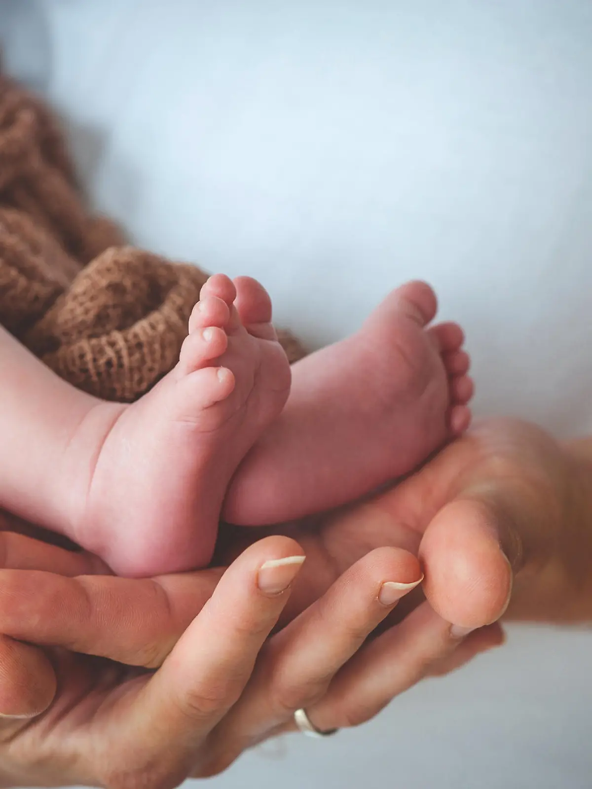 Mother and Father´s Hand Holding Baby´s Legs