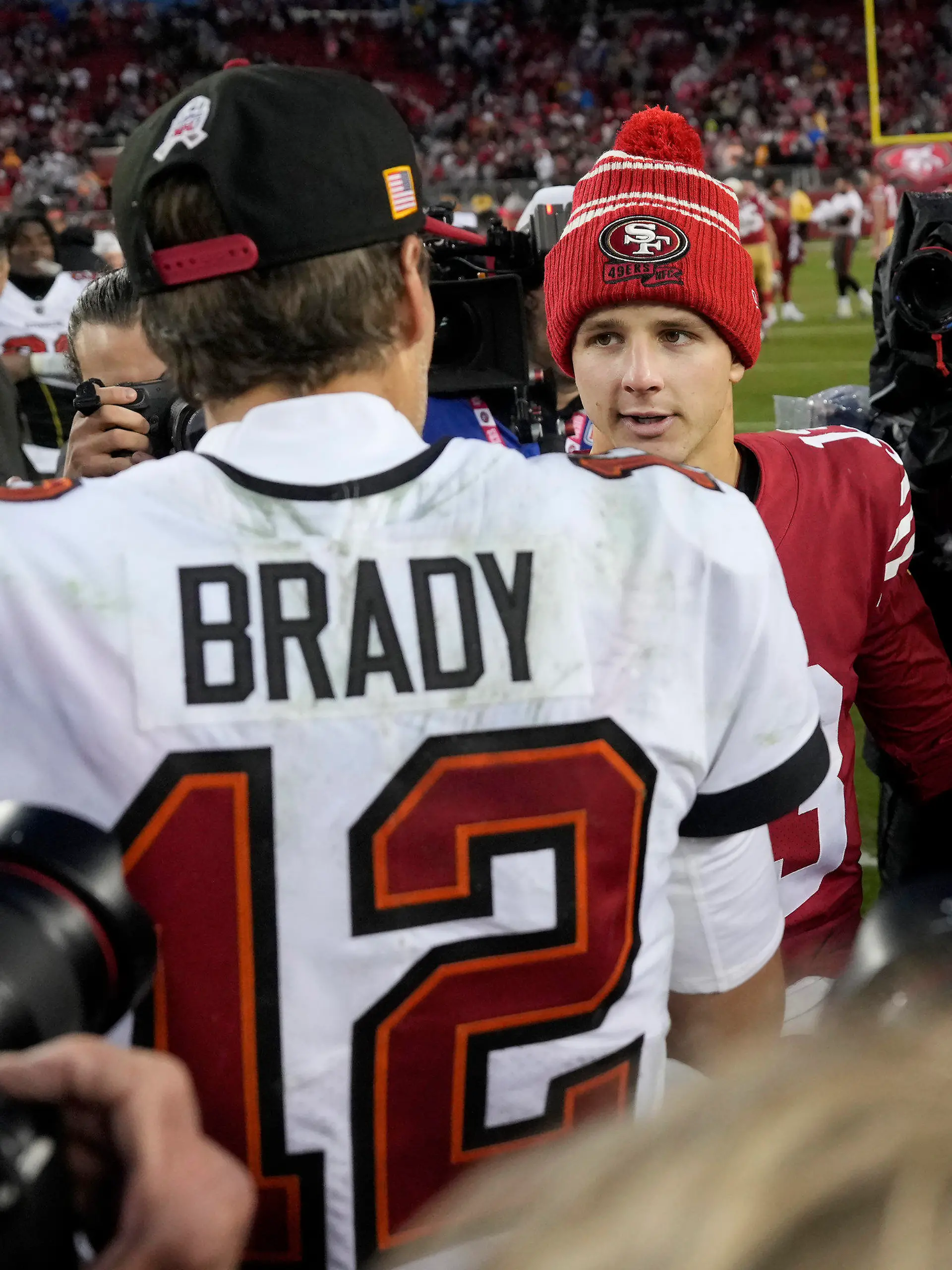 Tampa Bay Buccaneers quarterback Tom Brady (12) greets San Francisco 49ers quarterback Brock Purdy after an NFL football game in Santa Clara, Calif., Sunday, Dec. 11, 2022. (AP Photo/Tony Avelar)