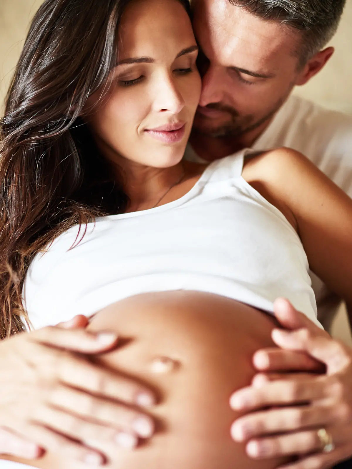 Shot of a husband and pregnant wife sitting together in a bedroom
