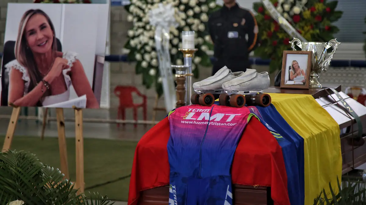 Racing roller skates sit on the coffin containing the body of Colombian world skating champion Luz Mery Tristan during her wake in Cali, Colombia, Monday, Aug. 7, 2023. According to authorities, Tristan was murdered on Saturday, Aug. 5, apparently at the hands of her partner who is now under arrest and about to be charged. (AP Photo/Andres Quintero)