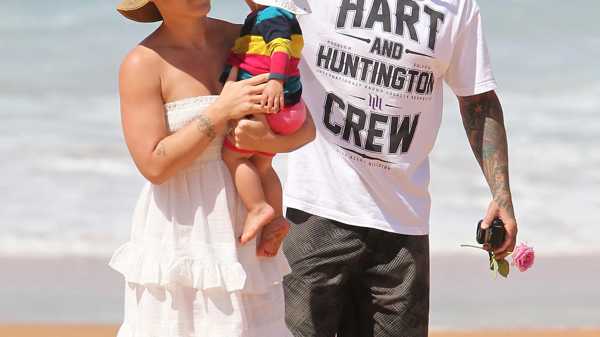 Pink and family enjoy a sunny day at the beach in Sydney.