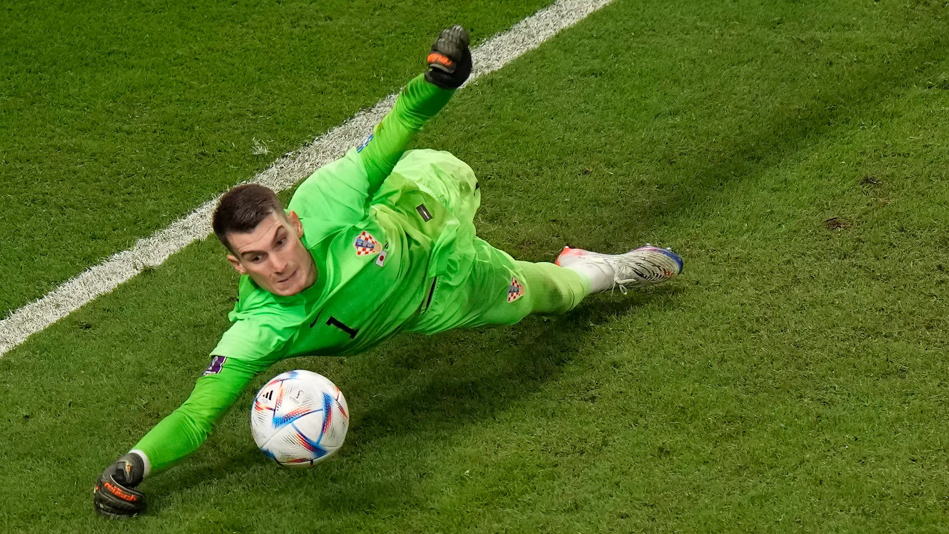 Croatia's goalkeeper Dominik Livakovic saves a penalty kick by Japan's Kaoru Mitoma during the World Cup round of 16 soccer match between Japan and Croatia at the Al Janoub Stadium in Al Wakrah, Qatar, Monday, Dec. 5, 2022. (AP Photo/Luca Bruno)