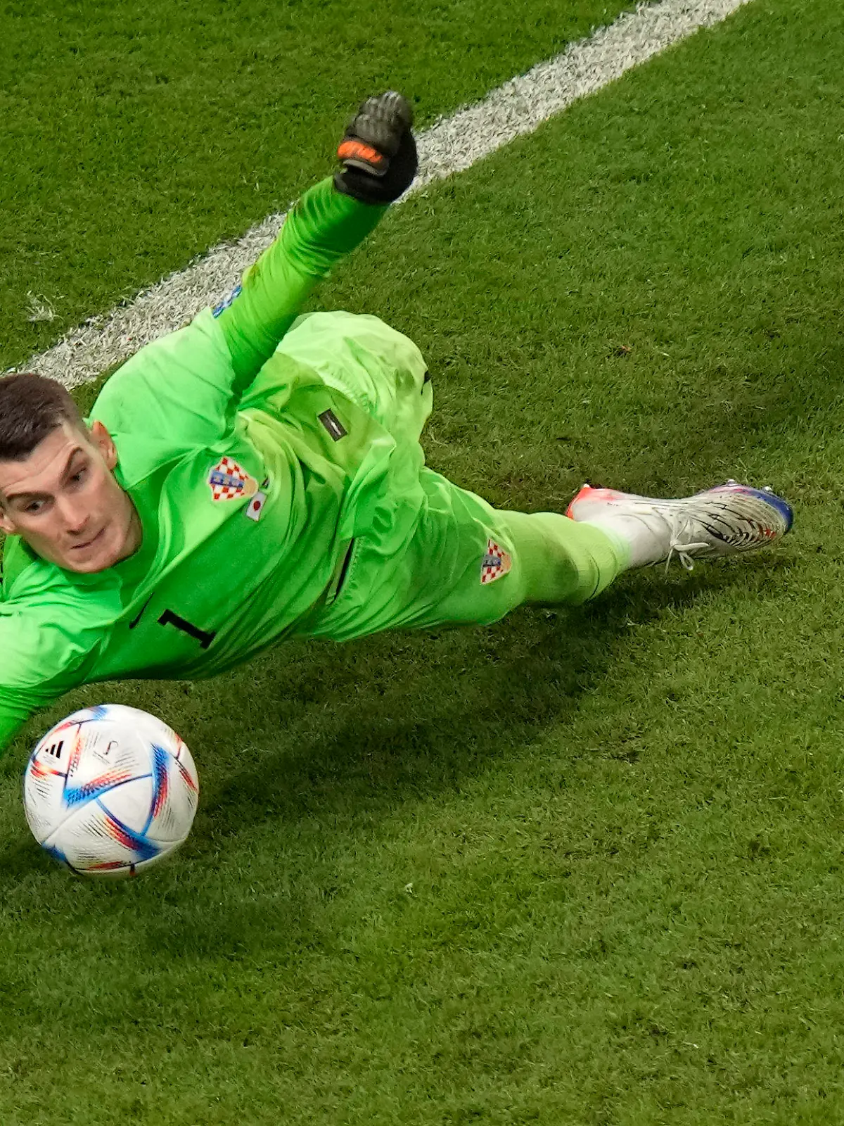 Croatia's goalkeeper Dominik Livakovic saves a penalty kick by Japan's Kaoru Mitoma during the World Cup round of 16 soccer match between Japan and Croatia at the Al Janoub Stadium in Al Wakrah, Qatar, Monday, Dec. 5, 2022. (AP Photo/Luca Bruno)