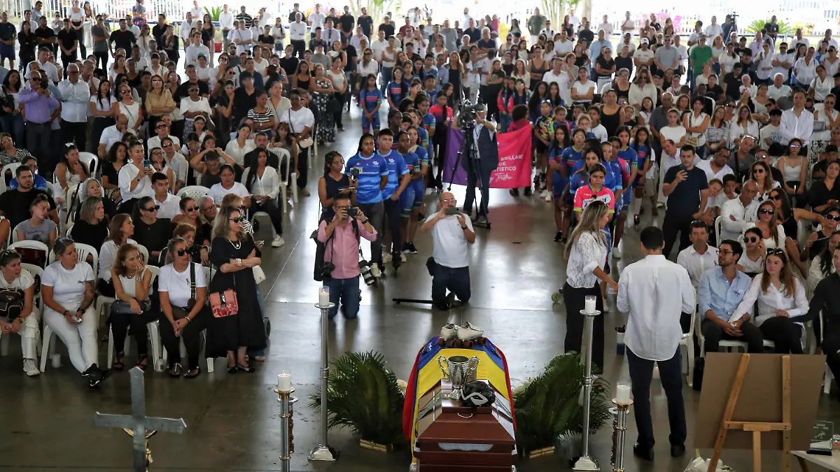 Friends and relatives of former Colombian world skating champion Luz Mery Tristan attend her wake in Cali, Colombia, Monday, Aug. 7, 2023. According to authorities, Tristan was murdered on Saturday, Aug. 5, apparently at the hands of her partner who is now under arrest and about to be charged. (AP Photo/Andres Quintero)