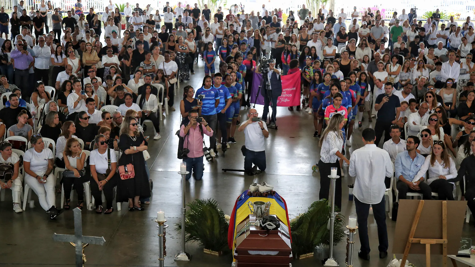 Friends and relatives of former Colombian world skating champion Luz Mery Tristan attend her wake in Cali, Colombia, Monday, Aug. 7, 2023. According to authorities, Tristan was murdered on Saturday, Aug. 5, apparently at the hands of her partner who is now under arrest and about to be charged. (AP Photo/Andres Quintero)