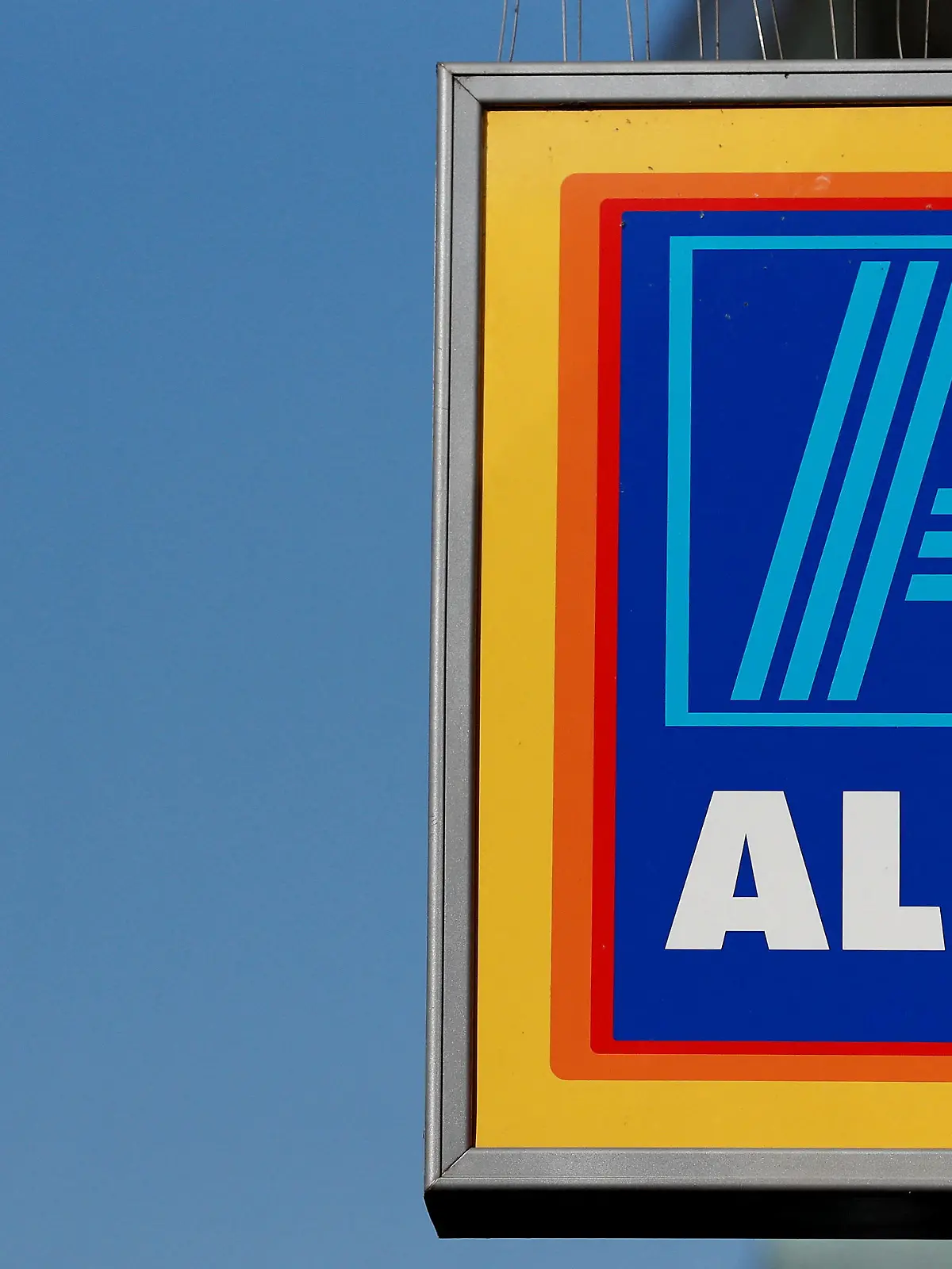 FILE PHOTO: FILE PHOTO: A company logo is pictured outside a branch of an Aldi supermarket in Manchester, Britain, March 17, 2016. REUTERS/Phil Noble/File Photo/File Photo