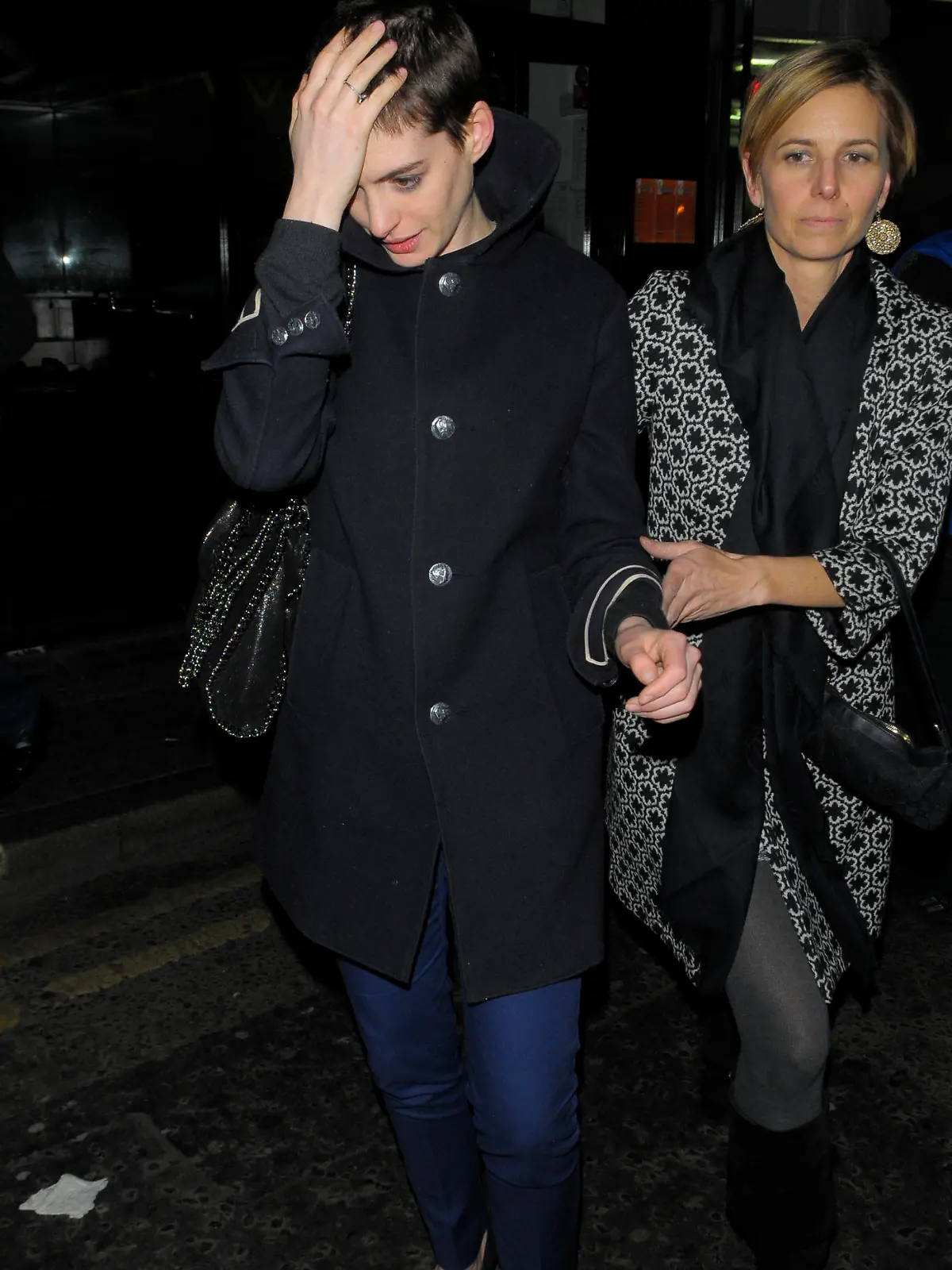 Anne Hathaway leaving The Box in London with short hair.