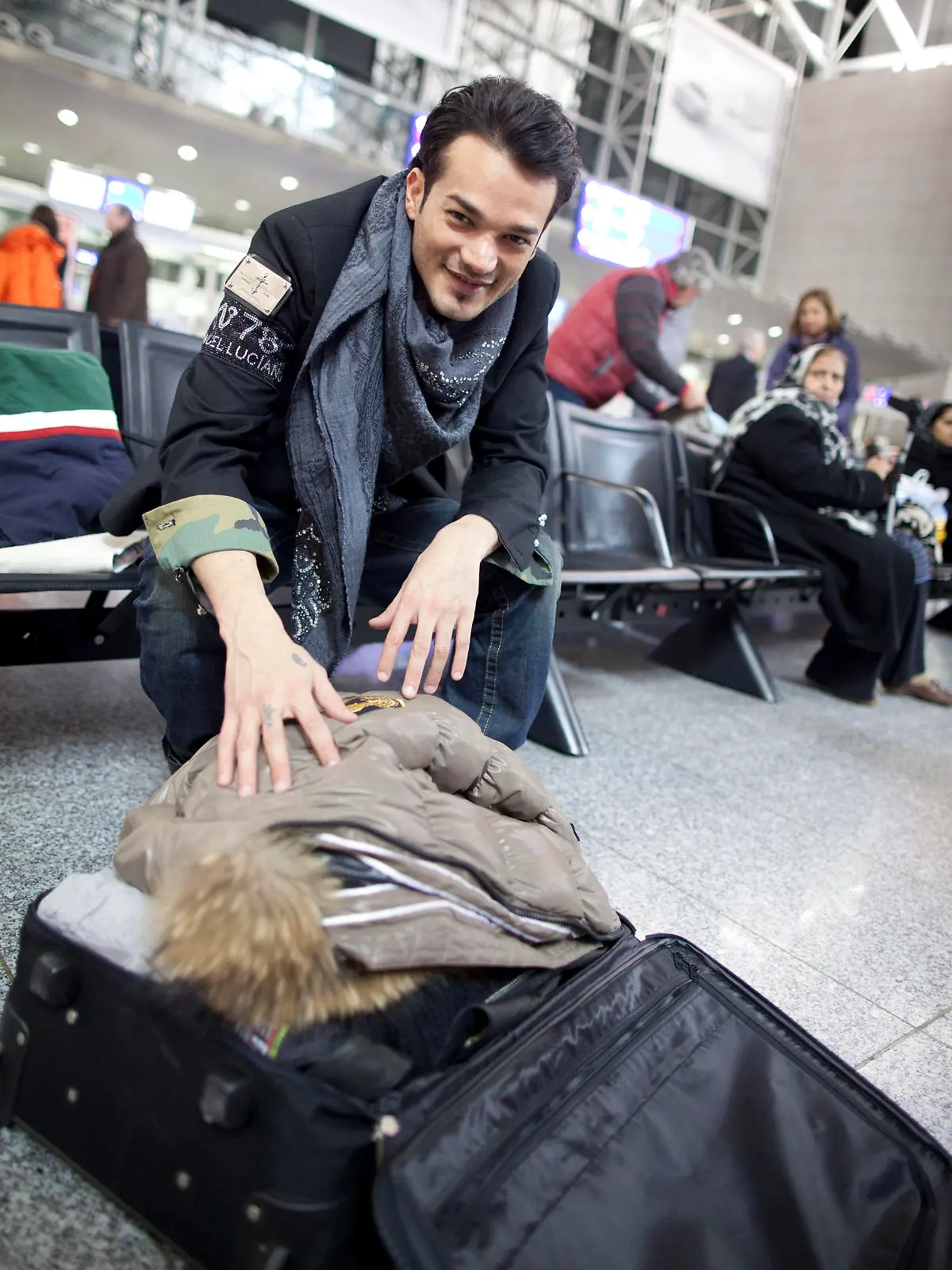 Sänger Daniel Lopes packt am Sonntag (08.01.2012) am Flughafen von Frankfurt am Main noch ein paar Kleidungsstücke ins Gepäck, während er auf den Abflug nach Australien wartet. Er gehört zu den elf Kandidaten der neuen Staffel des RTL-"Dschungelcamps". Vom 13. Januar an müssen die mehr oder weniger prominenten Teilnehmer maximal zwei Wochen lang in dem Lager im australischen Busch leben und dabei einige Prüfungen und Spiele absolvieren. Foto: Frank Rumpenhorst dpa/lhe  +++(c) dpa - Bildfunk+++