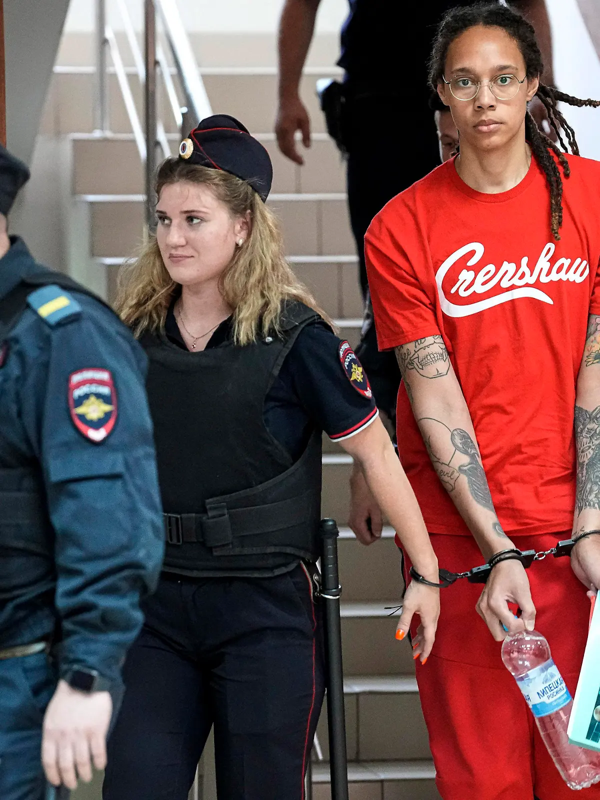 FILE - WNBA star and two-time Olympic gold medalist Brittney Griner is escorted to a courtroom for a hearing in Khimki just outside Moscow, on July 7, 2022. Russia has freed WNBA star Brittney Griner on Thursday in a dramatic high-level prisoner exchange, with the U.S. releasing notorious Russian arms dealer Viktor Bout. (AP Photo/Alexander Zemlianichenko, File)