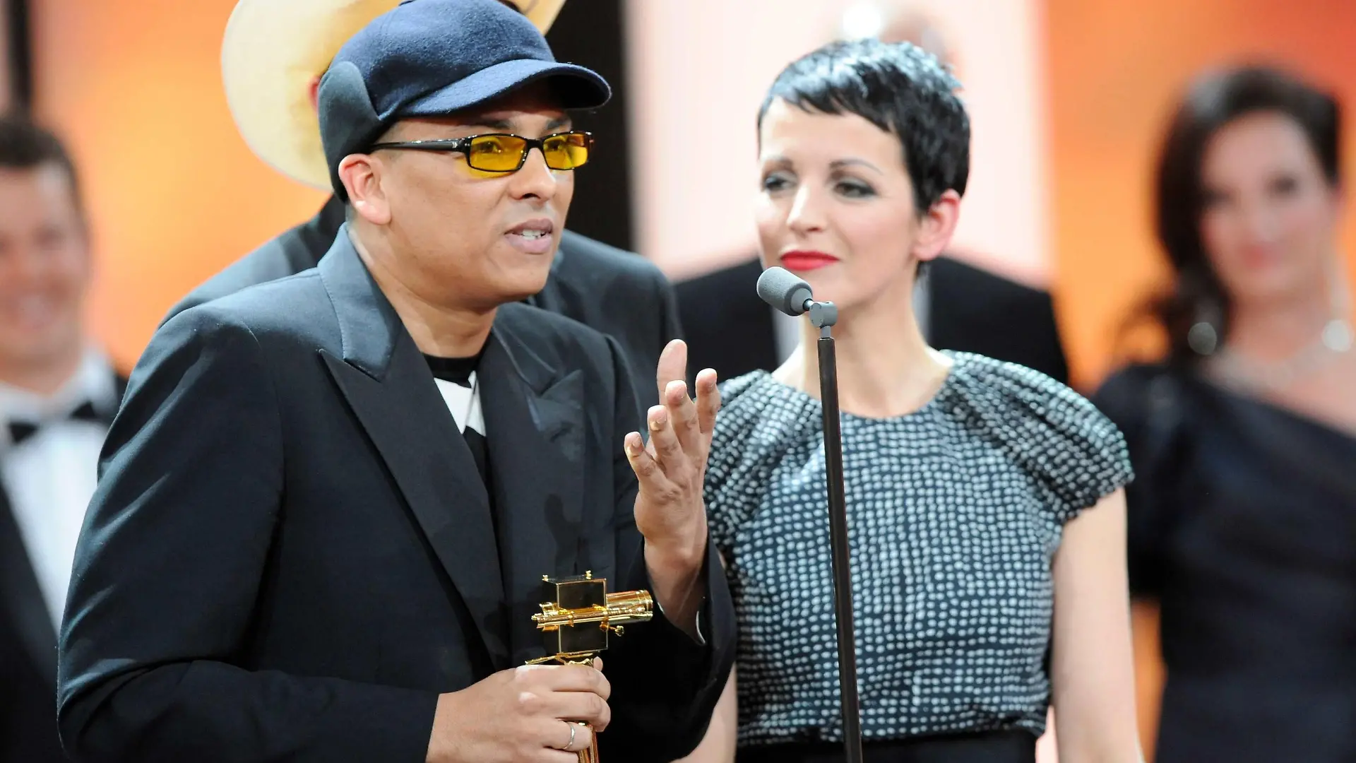 German singer Xavier Naidoo (L) and Nena from the jury of the vocalist talent search show "The Voice of Germany" hold their trophy for the Category "Best Entertainment Program" during the 47th Golden Camera award ceremony in Berlin February 4, 2012. The Golden Cameras (Goldene Kamera) are awarded by a popular German TV-magazine honouring excellence in the areas of television, film and entertainment. REUTERS/Maurizio Gambarini/Pool (GERMANY - Tags: ENTERTAINMENT)