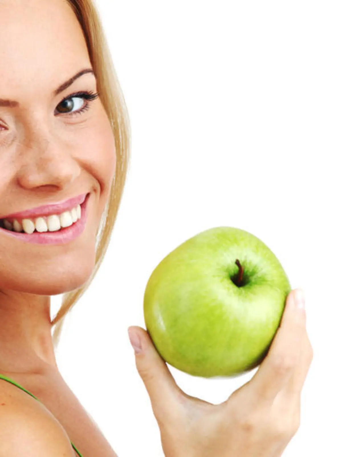 blond woman eat green apple on white