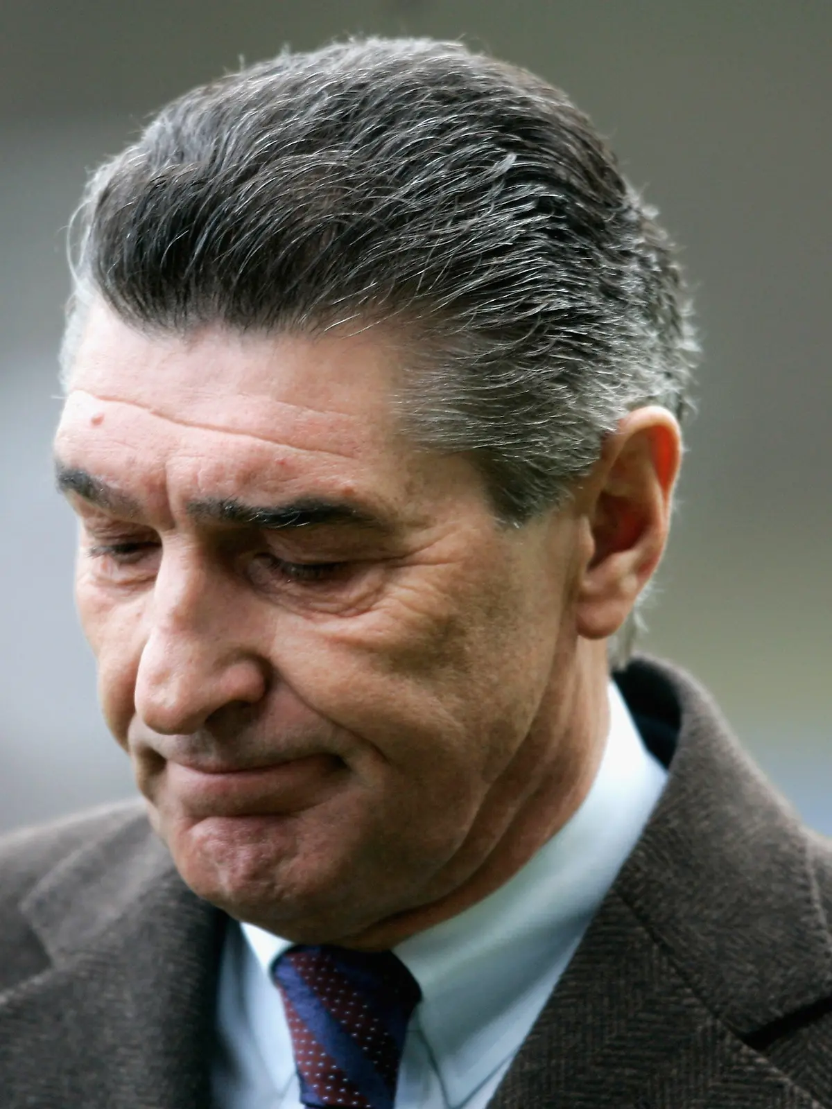 COLOGNE, GERMANY - JANUARY 08: Manager Rudi Assauer of Schalke is thoughtful before the friendly match between Viktoria Cologne and FC Schalke 04 at the Airport Stadium on January 8, 2006 in Cologne, Germany. (Photo by Christof Koepsel/Bongarts/Getty Images) *** Local Caption *** Rudi Asauer