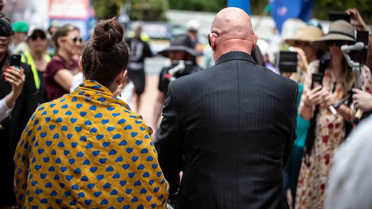 The mother and father of a four-month-old baby that urgently needs a heart operation leave the High Court in Auckland, New Zealand, Tuesday, Dec. 6, 2022. The court on Wednesday, Dec. 7, 2022, ruled against the family who had refused blood transfusions for their baby son unless the blood came from donors who hadn't been vaccinated against COVID-19. (Michael Craig/New Zealand Herald via AP)