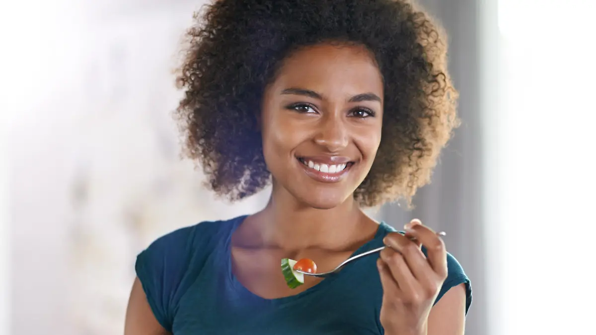 A beautiful young woman eating a bowl of salad at homehttp://195.154.178.81/DATA/shoots/ic_783564.jpg