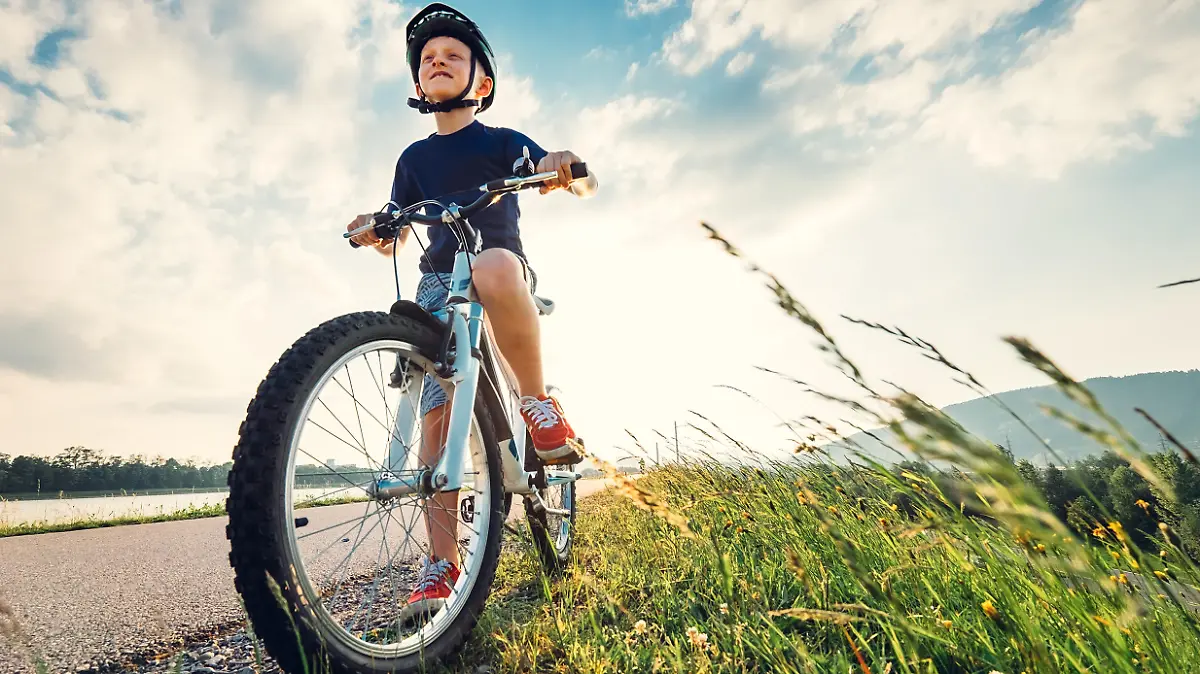 Boy start to ride a bicycle