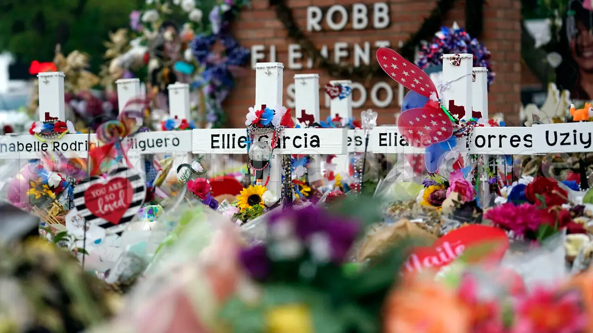 Crosses are surrounded by flowers and other items at a memorial at Robb Elementary School, Thursday, June 9, 2022, in Uvalde, Texas, created to honor the victims killed in the recent school shooting. Two teachers and 19 students were killed in the mass shooting. (AP Photo/Eric Gay)