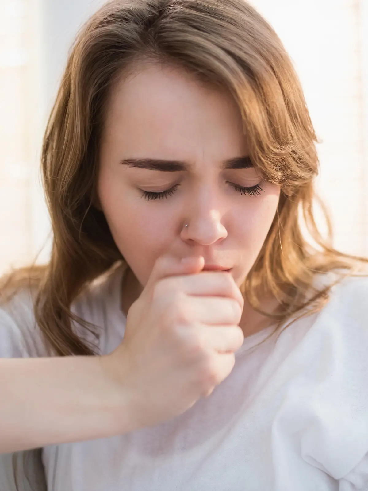 Pretty woman coughing in the living room