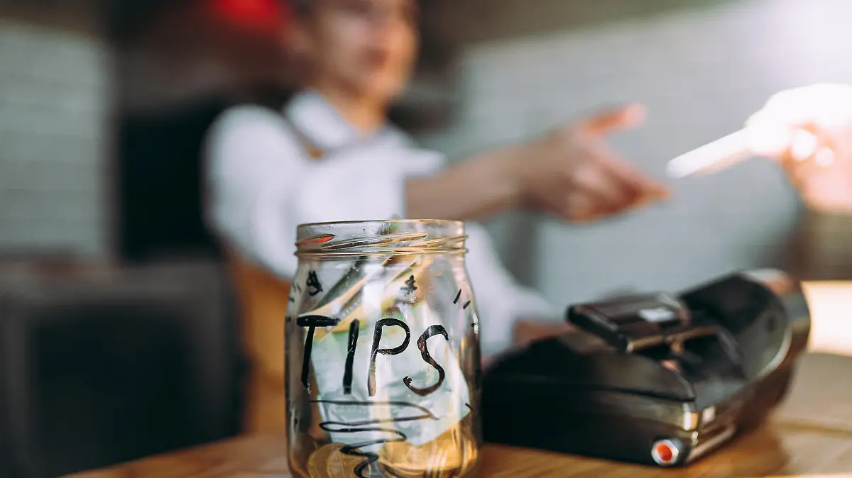 The woman pays for the food with a card