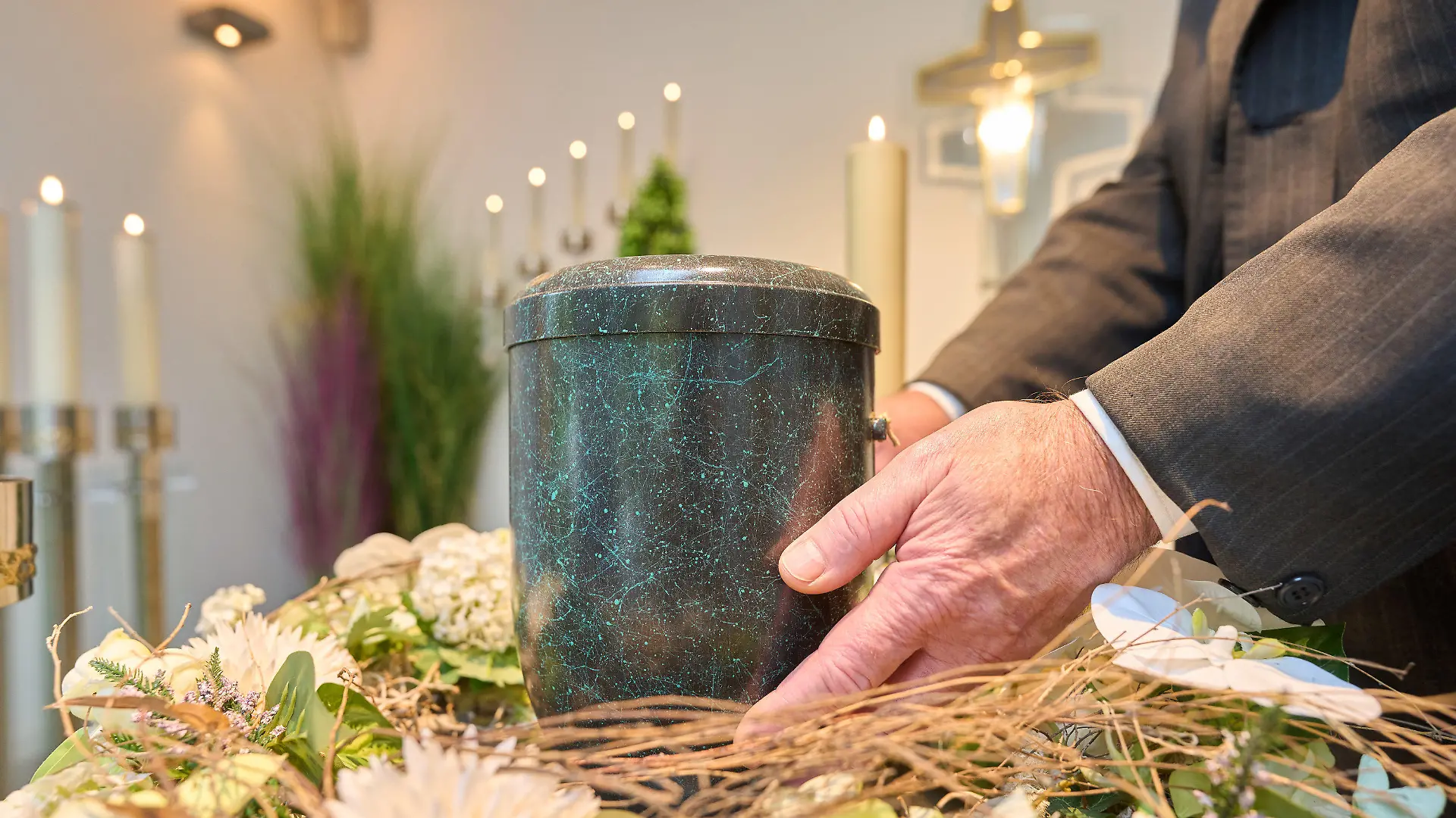PRODUKTION - 24.10.2022, Rheinland-Pfalz, Dachsenhausen: Bestatter Udo Feller platziert eine Urne im Andachtsraum des Krematoriums Dachsenhausen. Beim Blick auf den eigenen Tod geben sich 80 Prozent der Erwachsenen in Deutschland bescheiden. Das bringt eine repräsentative Umfrage des Meinungsforschungsinstituts YouGov im Auftrag der Deutschen Presse-Agentur ans Licht. (zu dpa: «Umfrage: 80 Prozent wollen für sich nur kleine oder keine Trauerfeier») Foto: Thomas Frey/dpa +++ dpa-Bildfunk +++