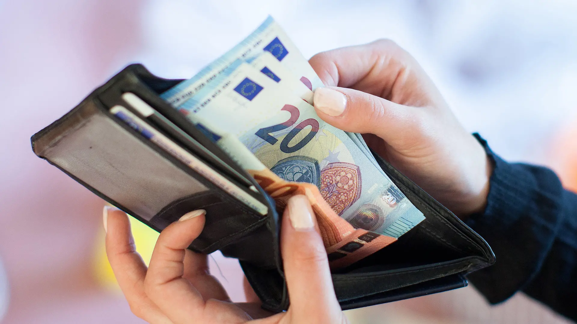 ARCHIV - 25.05.2016, Berlin: ILLUSTRATION - Eine Frau nimmt Banknoten aus einem Geldbeutel. Der Vermittlungsausschuss von Bundestag und Bundesrat soll am kommenden Mittwoch einen Kompromiss im Streit um das geplante Bürgergeld finden. Foto: Christin Klose/dpa +++ dpa-Bildfunk +++