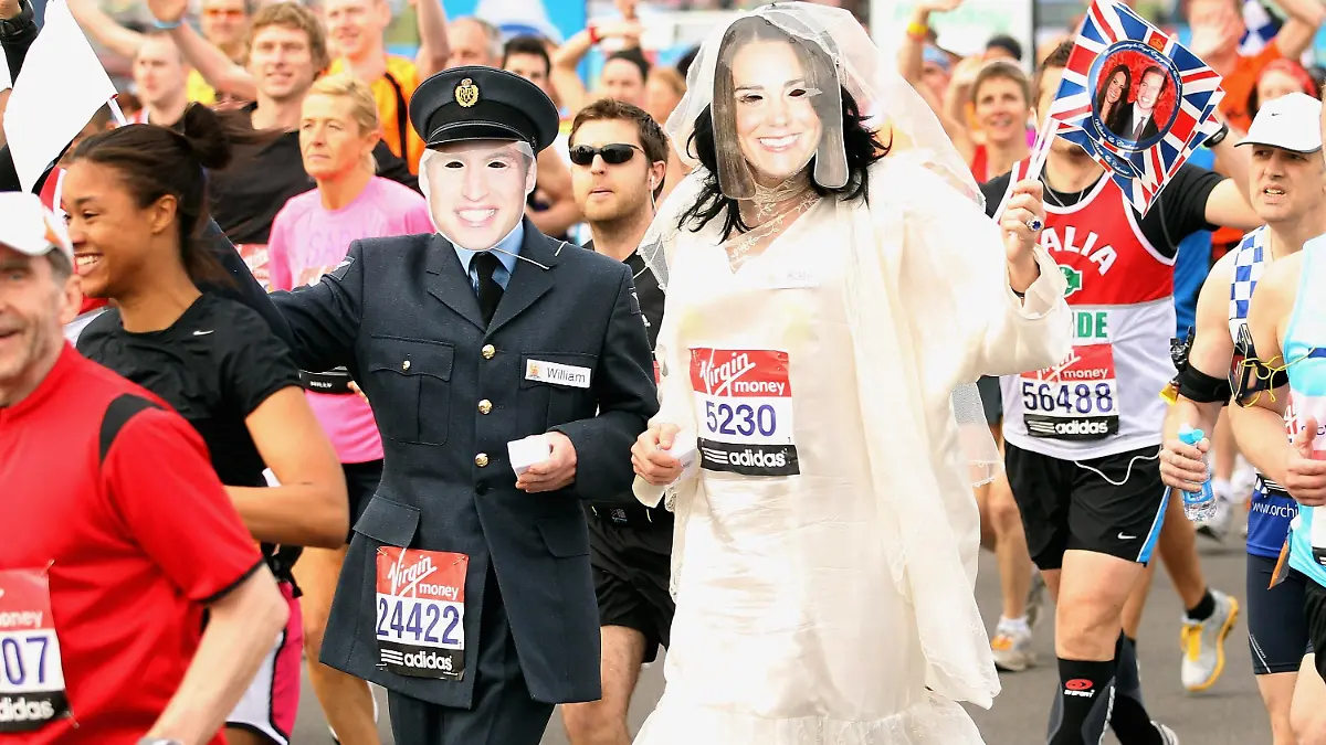 LONDON, ENGLAND - APRIL 17: Two competitors dressed at Prince William and his fiancee Kate Middleton wave at photographers during the start of the 2011 Virgin London Marathon on April 17, 2011 in London, England. (Photo by Andrew Redington/Getty Images)