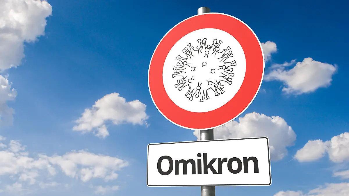 New mutation of corona virus named "omikron" B.1.1.529: Corona virus - Schematic image of a virus on a no entry sign with the the text "Omikron" below.
