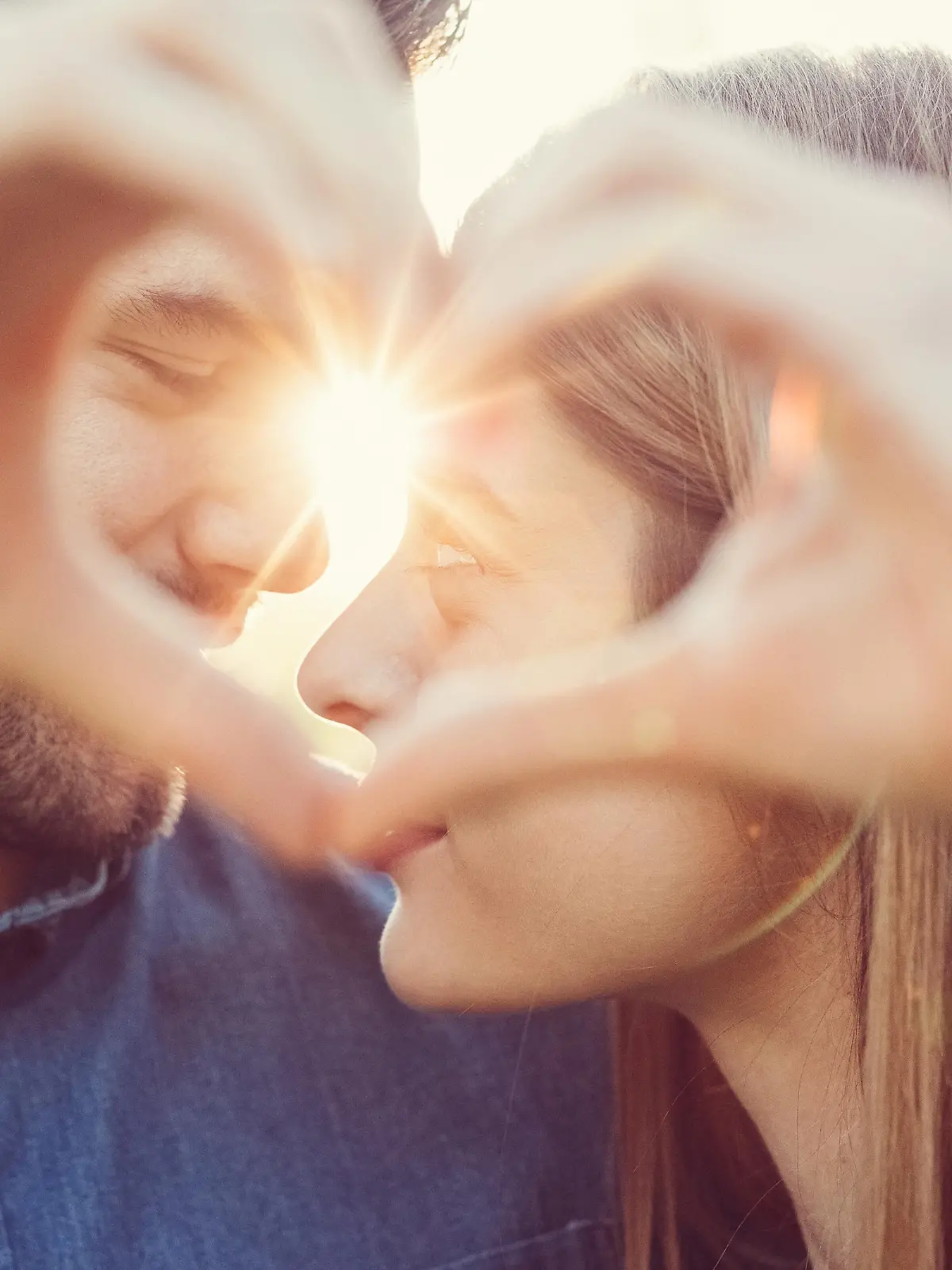 Young people showing a heart-shaped symbol with hands
