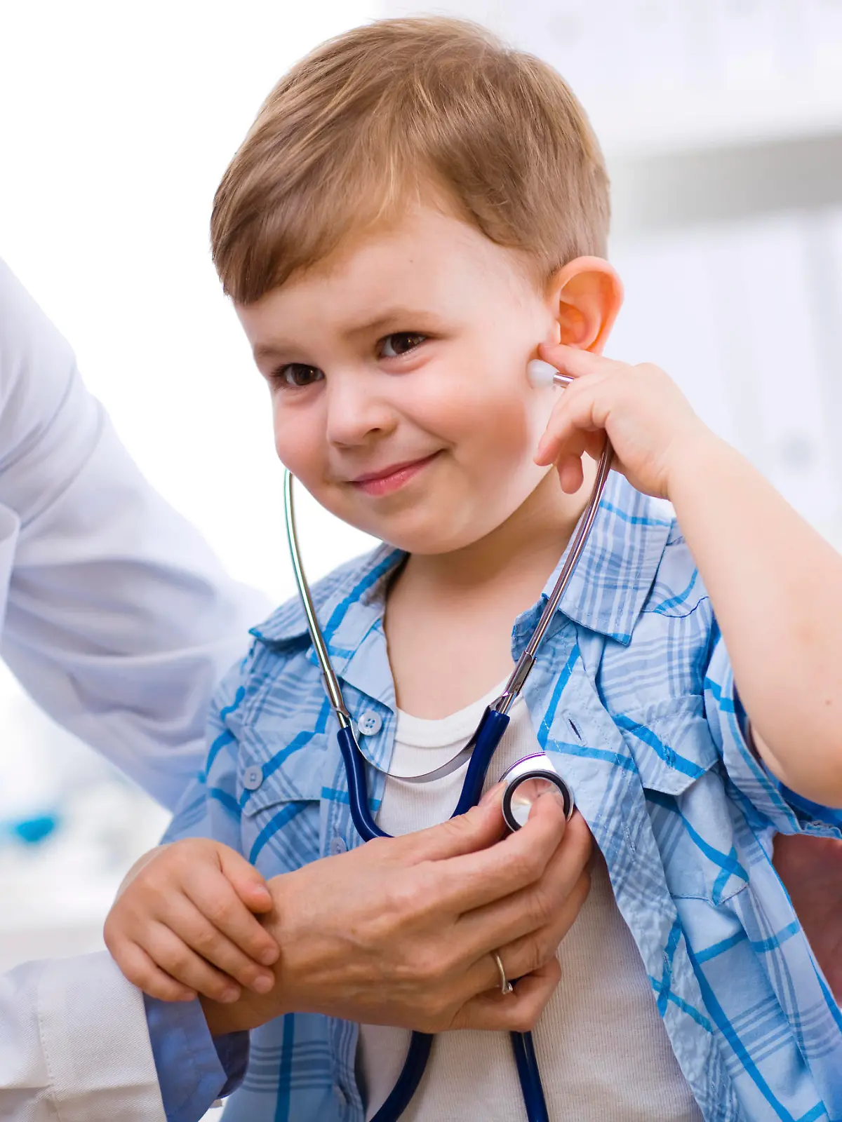 Senior female doctor examining happy child, smiling. Click here for more Medical photos 