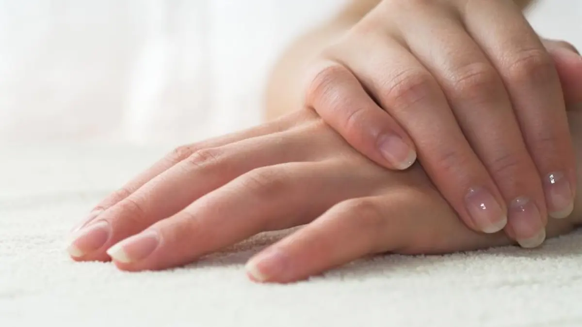 Nice hands on white towel. Soft manicure.