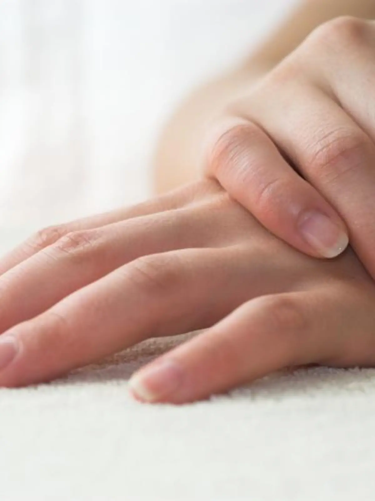 Nice hands on white towel. Soft manicure.