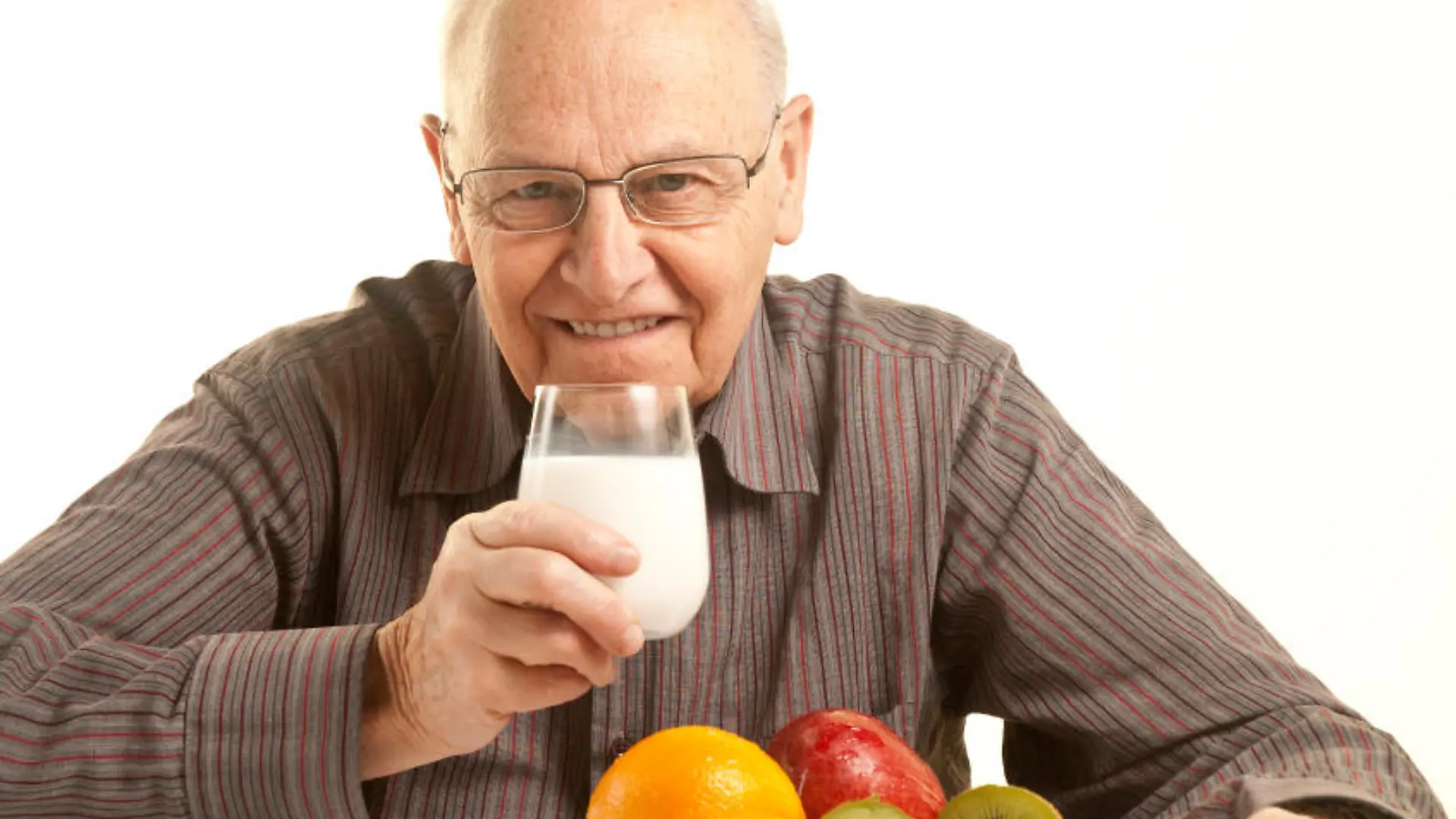 Senior man having a healthy breakfast isolated on white