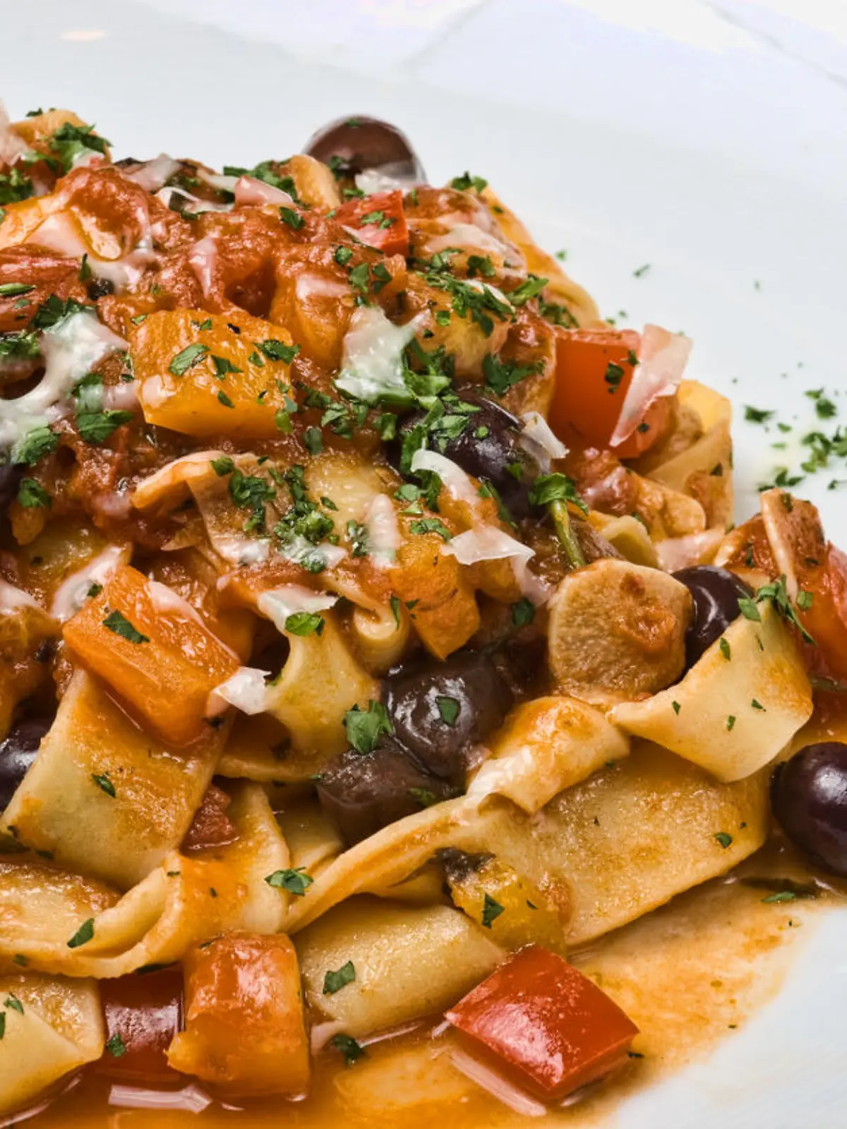 Pasta Puttanesca with olives, tomato, peppers, onions and parsley