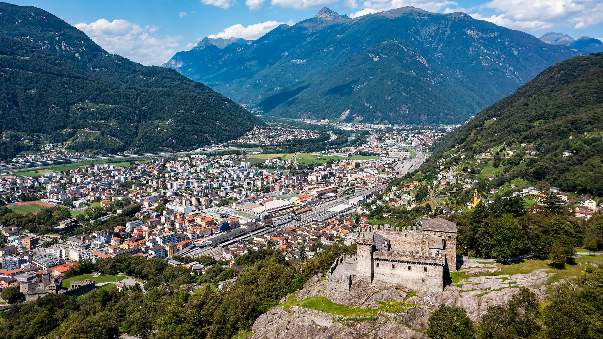 Switzerland, Ticino, Bellinzona, Aerial view of Sasso Corbaro castle overlooking town below RUNF04669